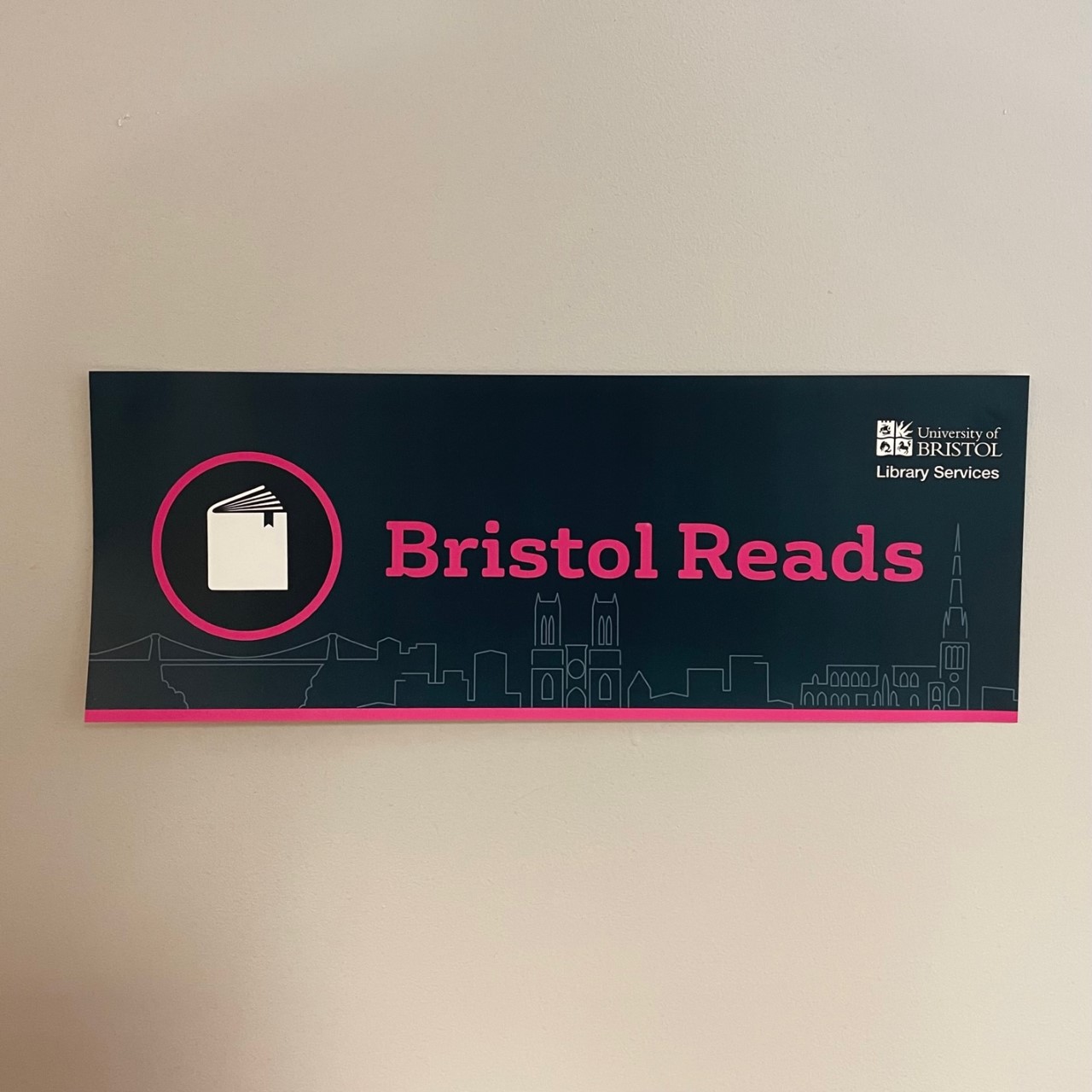 Navy sign reading 'Bristol Reads' in bright pink